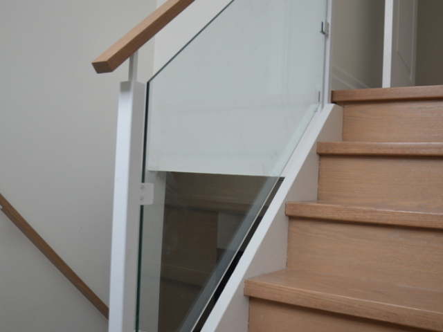 white glass railing with wood handrail