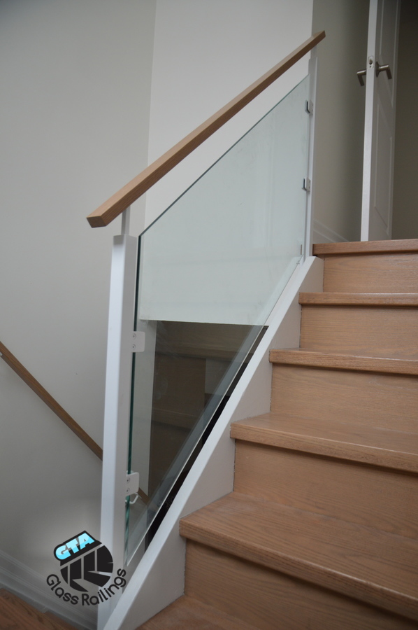 white glass railing with wood handrail