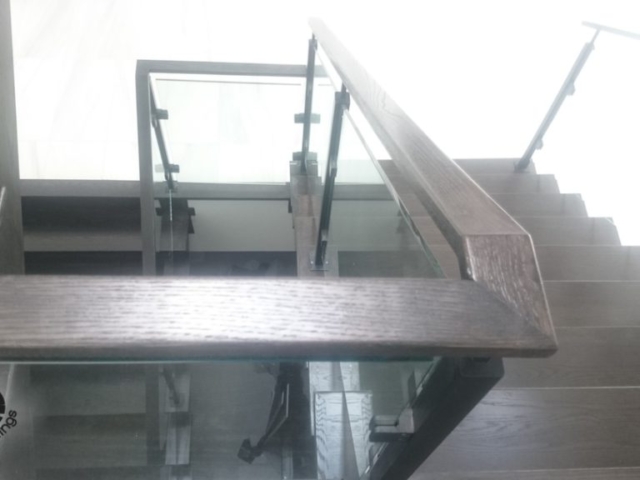glass railing with wood handrail