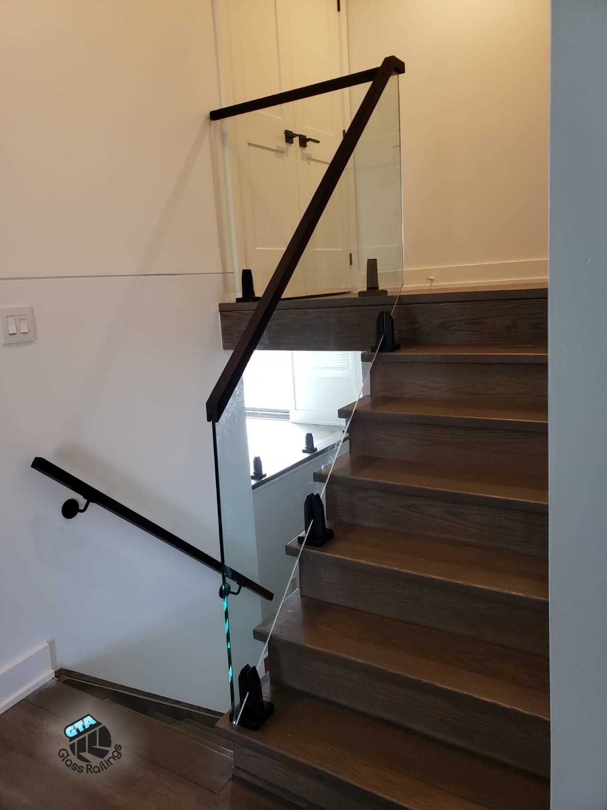 Glass railing wood handrail
