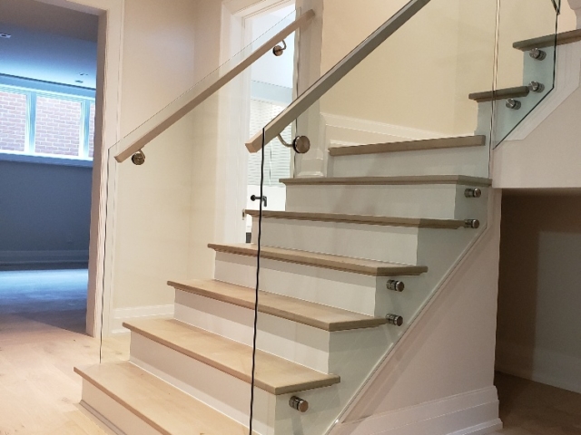 indoor frameless glass railing wood handrail
